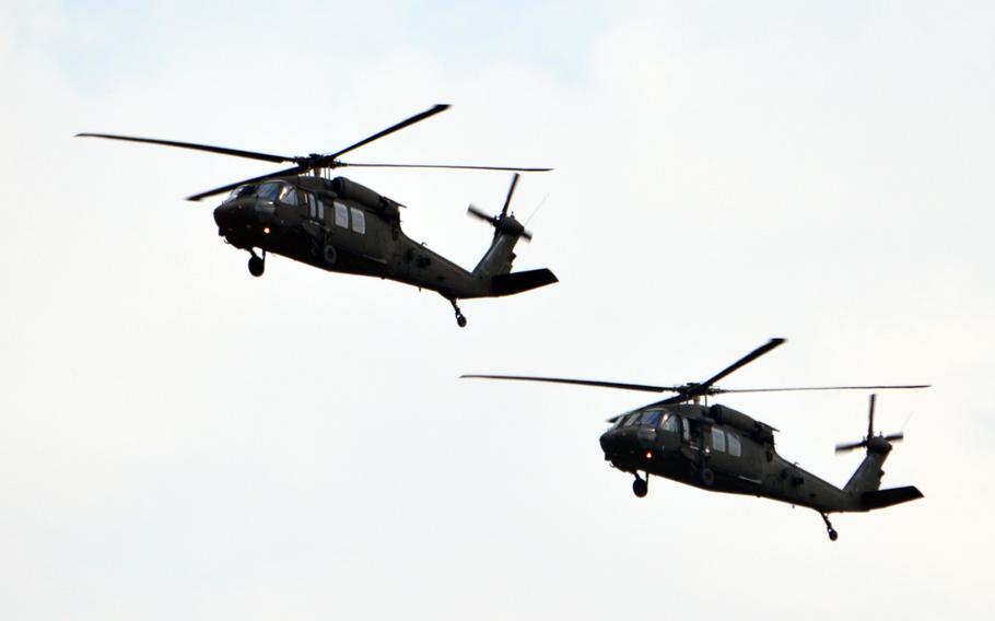 A pair of U.S. Army UH-60 Black Hawks flies over Camp Humphreys, South Korea on Oct. 10, 2013.