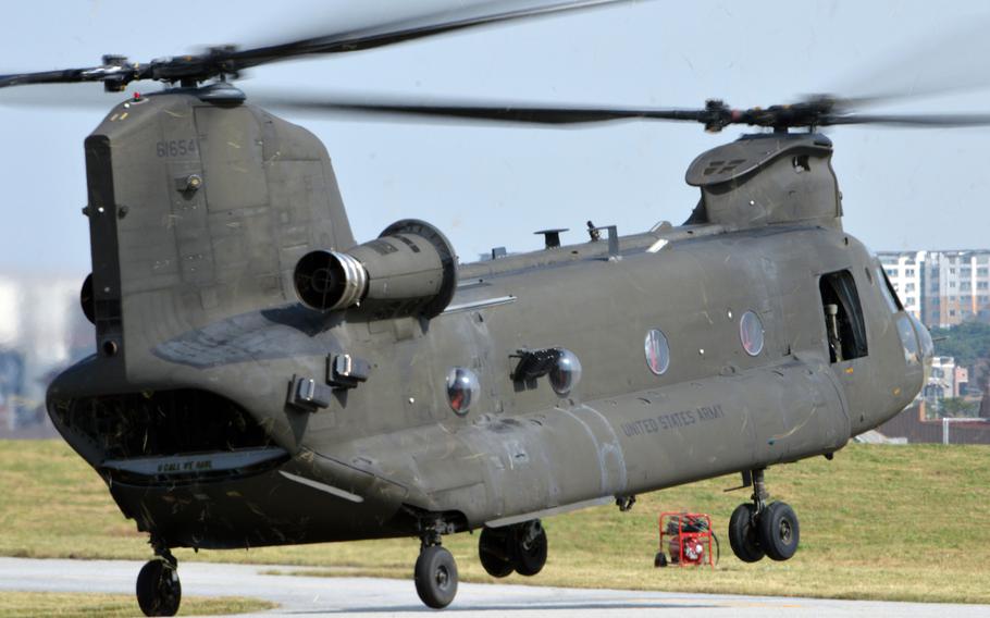 U.S.  Army CH-47 Chinook taxis backwards from its parking spot at Camp Humphreys, South Korea on Oct. 10, 2013. The backwards taxi while pivoting on a corner rear landing gear is a difficult and unusual maneuver.