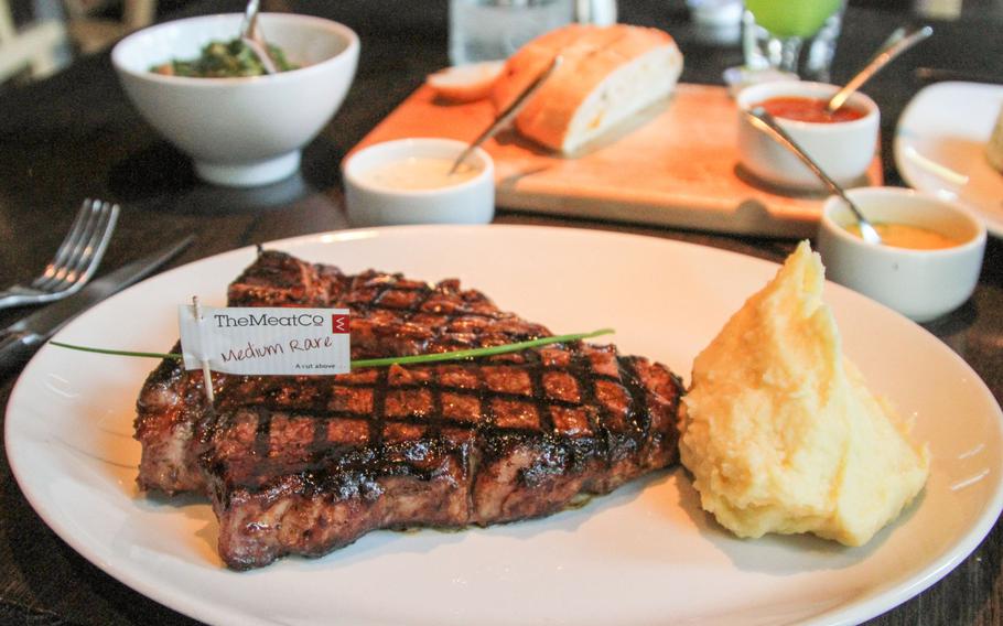 At The Meat Co restaurant in Bahrain, steaks come with a basic side dish -- mashed potatoes or vegetables. Choose from a variety of sauces, such as creamy garlic and peri peri, pictured in the background. Every meal comes with complimentary bread.