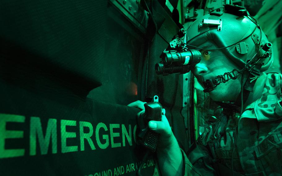Senior Airman Larry Webster, 774th Expeditionary Airlift Squadron loadmaster, scans for potential threats using night-vision goggles after completing a cargo airdrop in Ghazni province, Afghanistan, on Oct. 7, 2013.
