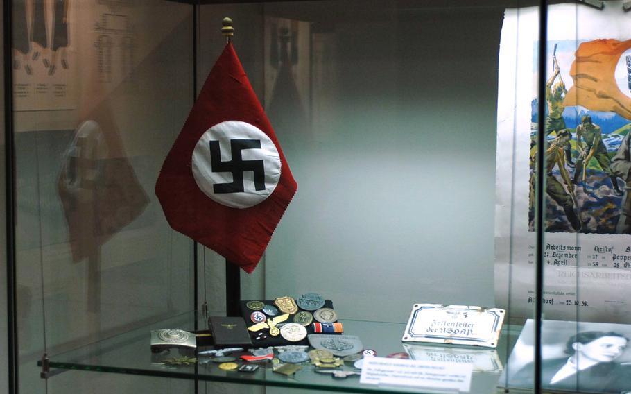 A Nazi flag and related paraphernalia are displayed at Stadtmuseum Schwabach in Schwabach, Germany. The museum, located near Nuremberg, features artifacts from World War II and the city's gold industry, among other items. Its main building was once home to the U.S. Army's O'Brien Barracks.