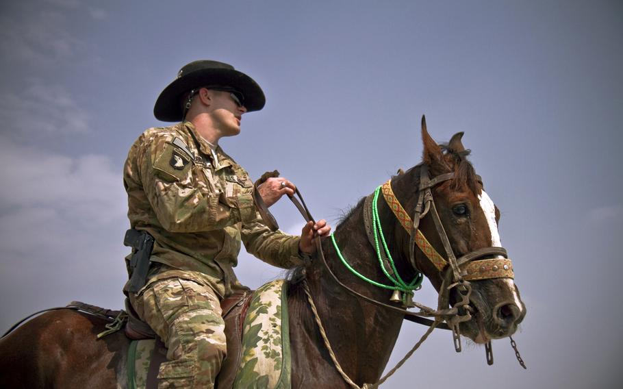 First Lt. Jeremy A. Woodard, an engineer officer with 1st Squadron, 61st Cavalry Regiment, 4th Brigade Combat Team, 101st Airborne Division (Air Assault), sits atop a horse, during a spur ceremony at Camp Clark, Afghanistan, Oct. 11, 2013.