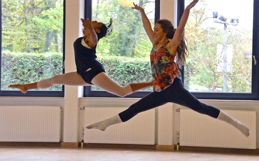 Rota's Sofia Ortiz, right, and Ashley Calabro of Naples leap through the air during a  dance rehearsal at Creative Connections. More than 160 students from DODDS-Europe high schools participated in this year's week long event that features 11 workshops in the visual and performing arts.