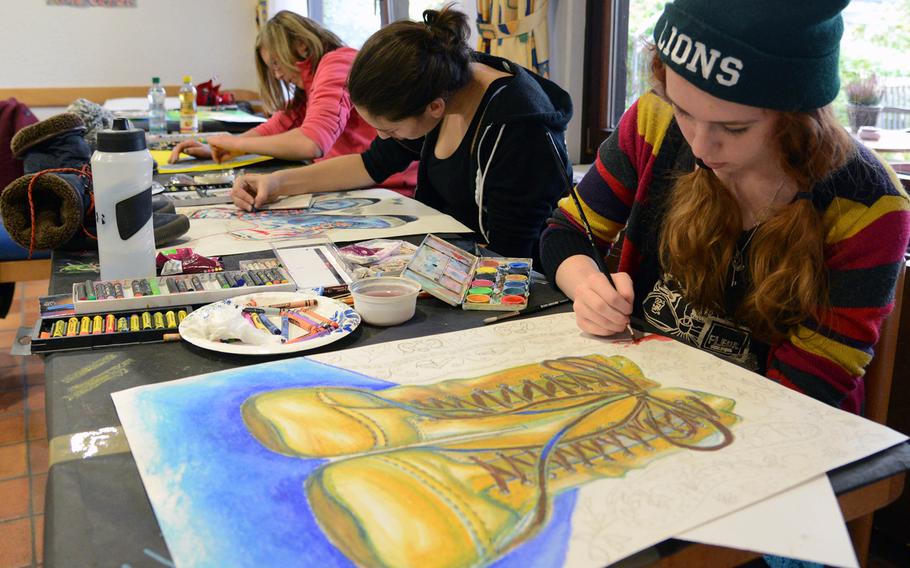 AFNORTH's Hailey Jenkins, Cassidy Harless and Eliska Volencove, from right, work on their art in the oil pastels workshop at Creative Connections. More than 160 students from DODDS-Europe high schools participated in this year's event that features 11 workshops in the visual and performing arts.