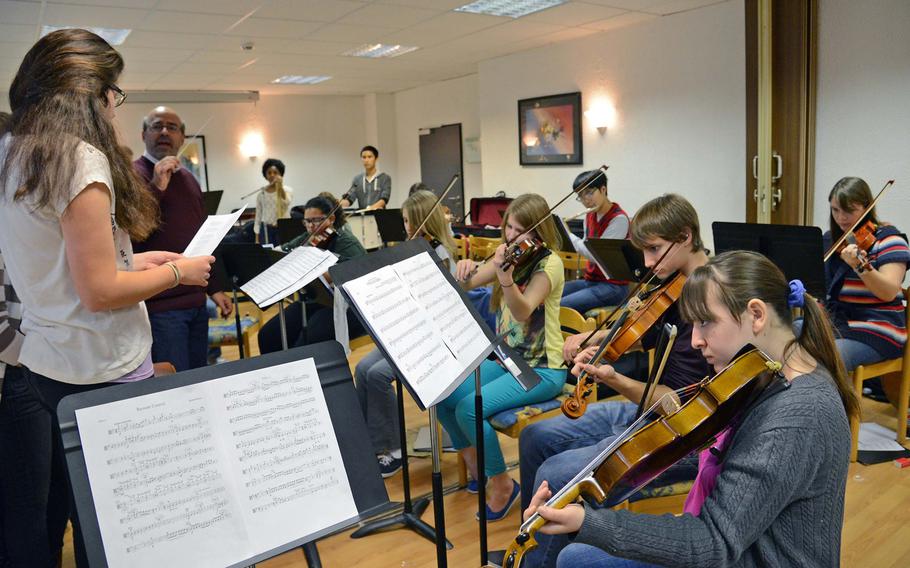 Under the direction of Cary Sand, second from left, the strings workshop practices Coldplay's "Viva La Vida" at this year's Creative Connections. More than 160 students from DODDS-Europe high schools participated in this year's event that features 11 workshops in the visual and performing arts.