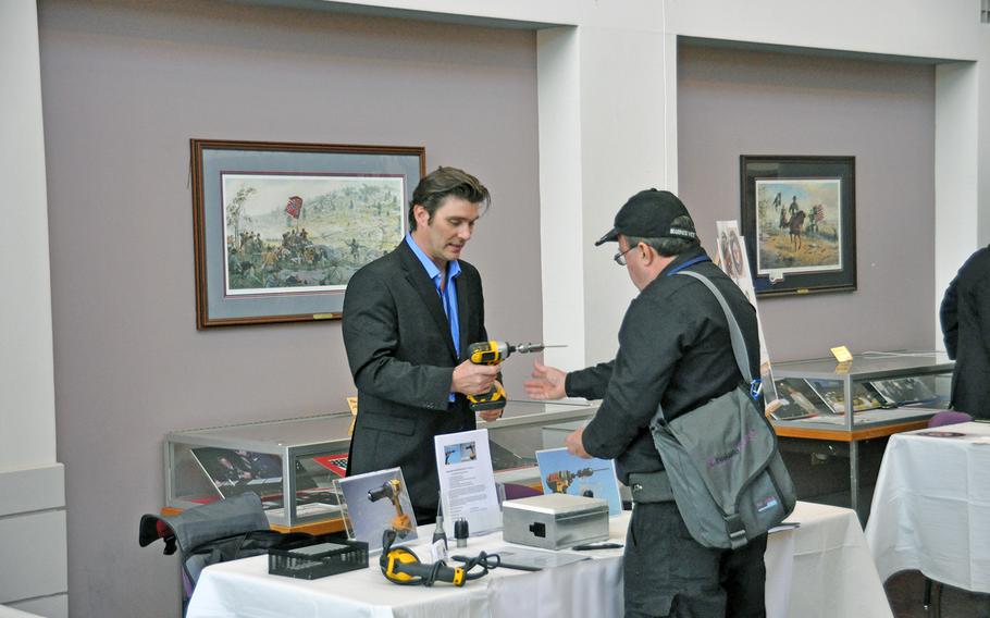 Army veteran Walter Nagel III shows off his "SHUR-A-TAK" universal screw attachment to a potential investor at the Veterans Venture Forum event on Oct. 29. The event paired veteran entrepreneurs with individuals and firms looking to invest in new start-ups.