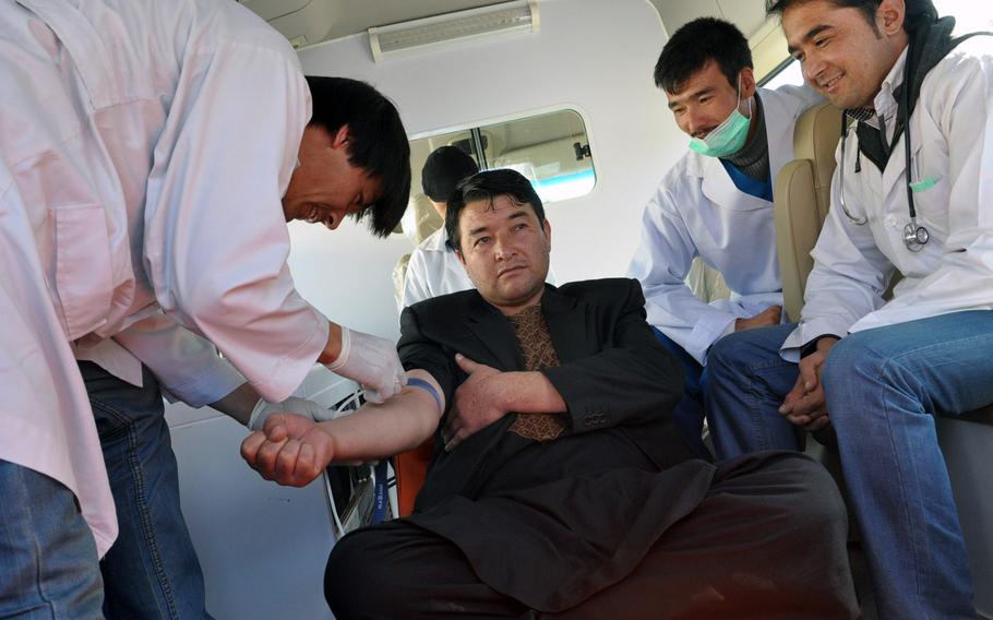 A man donates blood in Bamiyan, Afghanistan, Thursday before services for Ashura, one of the holiest days of the year for Shia Muslims. While some Shias whip themselves bloody for the holiday, the governor of Bamiyan province encouraged the faithful to donate blood instead.