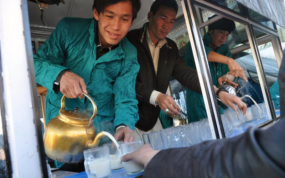 Afghans pour sweet hot milk to worshippers leaving Ashura services Thursday in Bamiyan, Afghanistan. Ashura is a day of mourning for Shia Muslims, commemorating the martyrdom of Hussein Ibn Ali, grandson of the prophet Muhammad.