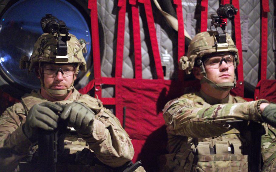 Staff Sgt. Donald Thornton, mortars section leader, and Spc. Aaron Greenwood, a mortarmen, wait for the CH-47 Chinook to depart for their exercise from Camp Marmal, Afghanistan, on Nov. 9, 2013.