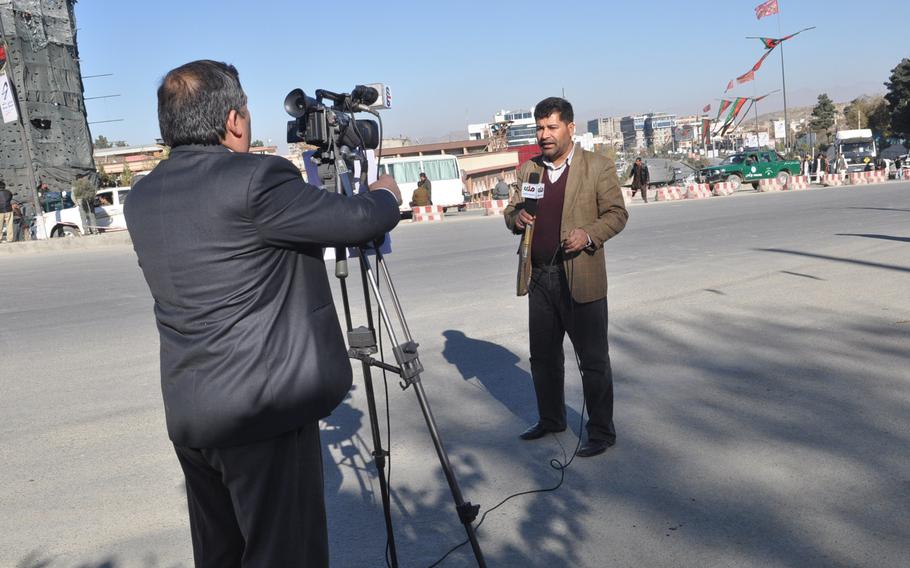 A TV reporter sets up a live shot on a road leading the building hosting the Loya Jirga, a council of elders and local leaders from around the country, which begins Wednesday. The council will be considering a proposed U.S.-Afghan security accord that is a pre-condition for the U.S. to keep troops in the country beyond 2014.

Heath Druzin/Stars and Stripes