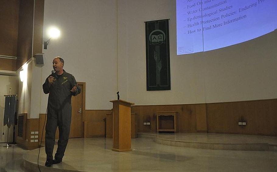 Capt. Scott Gray, commander of Naval Support Activity Naples, speaks during a townhall meeting on Nov. 21, 2013, to address media reports about toxic waste dumping near the southern Italian city.