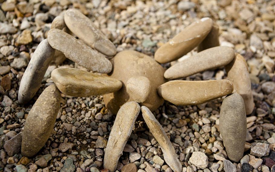 A stone spider sits outside the living quarters of servicemembers with Marine Medium Tiltrotor Squadron.