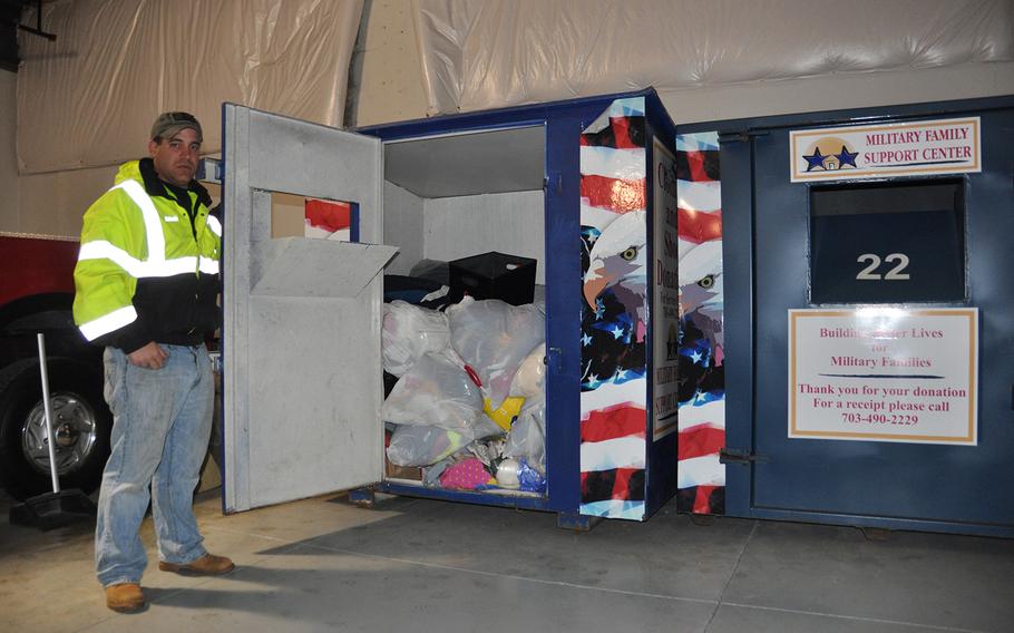 Adam Leitao, veteran of Iraq and Afghanistan who runs Adam's Towing in Leesburg, Va., shows off the contents of one of the misleading Military Family Support Center bins that he has impounded in recent months. The military charity does not collect items in the bins and receives no compensation for the use of their name.