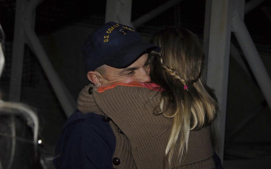 Petty Officer 1st Class John Savastano, assigned to Coast Guard Cutter Waesche, hugs his daughter at Coast Guard Island in Alameda, Calif., Friday, November 29, 2013. The Waesche's crew returned from a 109-day deployment in Gulf of Alaska, Bering Sea and Arctic Ocean.
