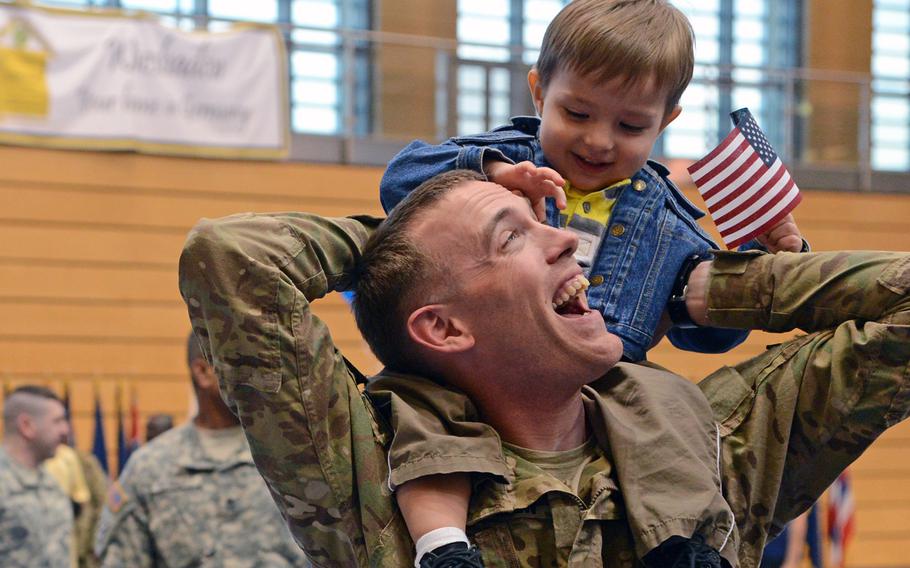 Mason Nielsen welcomes his dad, Sgt. Brent Nielsen, back from Afghanistan, after he and almost 150 other V Corps soldiers returned to Wiesbaden, Germany, April 23, 2013.