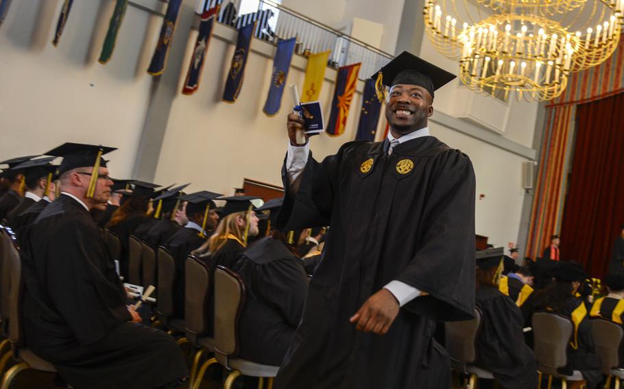 Yannick Gibbs smiles to someone in the crowd at the last University of Maryland University College commencement to take place in Heidelberg, Germany, May 4, 2013.