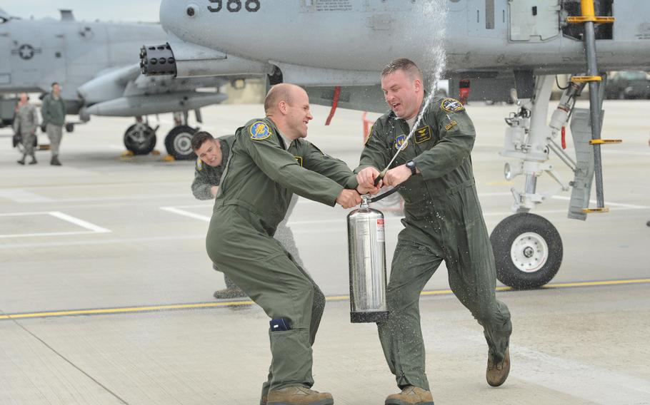 First Lt. Matt Kading, left, tries to hose down Capt. Josh Geidel after Geidel piloted a Spangdahlem, Germany-based A-10 on its final tactical training mission in Europe, May 14, 2013. The A-10s left Spangdahlem in May and the 81st Fighter Squadron inactivated in June.