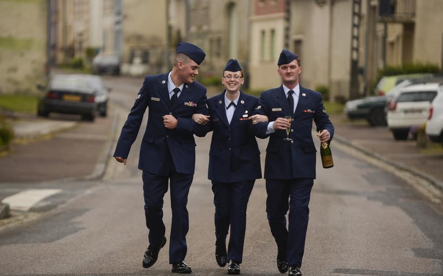 From left, U.S. Air Force Senior Airman Aaron Dickerson, Airman 1st Class Bonnie Burks, Airman 1st Class Josiah Austin, all from Ramstein Air Base, Germany, head to their bus after attending a reception in conjunction with a Memorial Day ceremony at the Meuse-Argonne American Cemetery and Memorial in France, May 26, 2013. Airmen from Ramstein volunteered to participate in the ceremony.