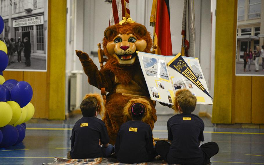 Heidelberg High School's mascot, the lion, reads "The Real HHS Story Begins" to lion cubs at the school's closing ceremony  in Heidelberg, Germany, May 31, 2013.