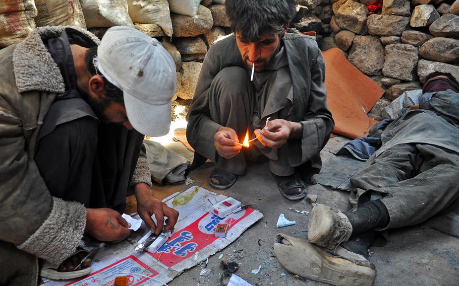 Men prepare heroin in Dahne Kamarkalagh, a colony of drug addicts on the outskirts of Herat, a city in western Afghanistan. Though Herat has been more prosperous and peaceful than much of the rest of the country, it has an estimated 60,000 to 70,000 drug addicts, most hooked on heroin and other opiates.