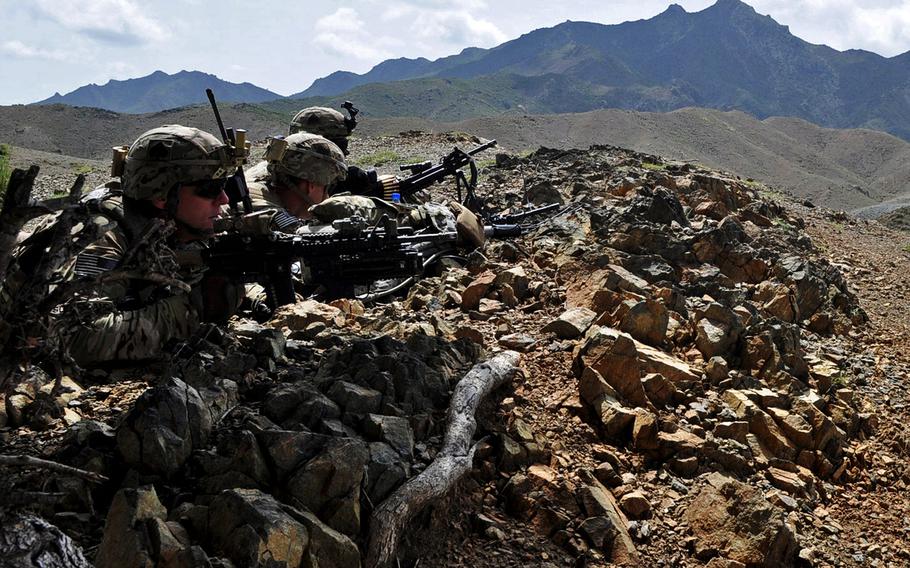 From left, Sgt. Joshua Sutherland, 1st Lt. James Kromhout, and Pfc. Alex Bolden set up a blocking position to provide security while Afghan forces search a village in Khost province in August 2013.