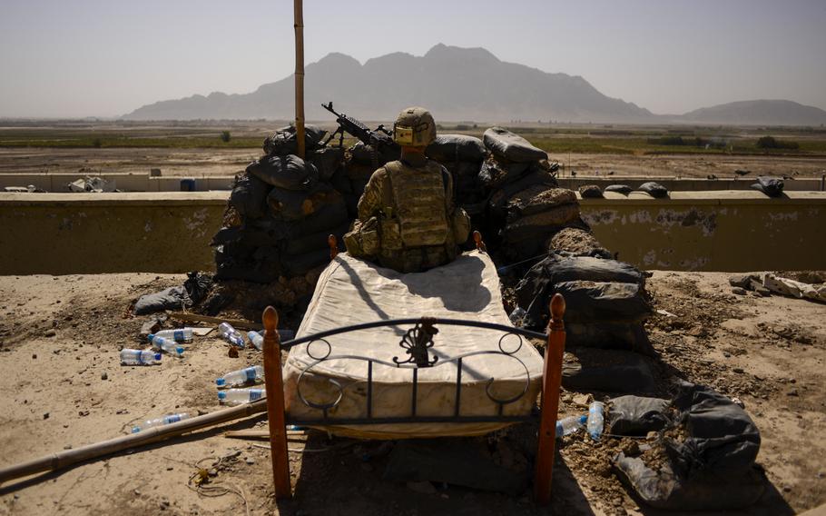 Spc. Derek Smith, a gunner with the 2nd Cavalry Regiment, pulls security from the roof of the Panjwai district headquarters in southern Afghanistan's Kandahar province on Oct. 5, 2013.