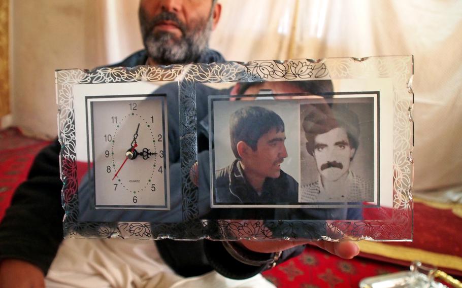 Mohammad Yasin holds a photo of his nephew,  Ayoub Khan, who has been missing since August. After Khan disappeared, Yasin's family called in to the popular Afghan radio show "In Search of our Missing Loved Ones" to ask for help in finding him.