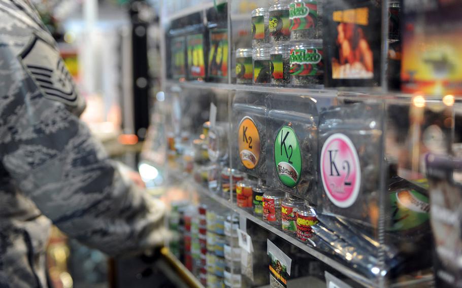 An Airman passes a spice display in a local smoke shop prior to a Nov. 24 ban by on the substance by the Drug Enforcement Agency. Spice and other mood-altering substances are banned by the Air Force, but were legal to sell in the civilian community until the DEA used its emergency powers to implement a one-year ban of the substance.