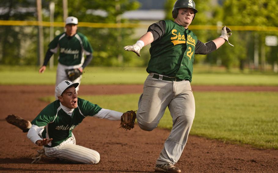 Naple's Dakota Bartley tags out SHAPE's Clay Coon in a game at the DODDS-Europe baseball championships at Ramstein Air Base, Germany, May 24, 2013.