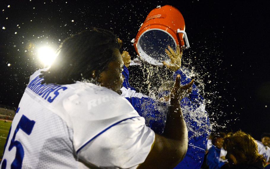 Wiesbaden players dump water on head coach Steven Jewell after defeating Ramstein in the DODDS-Europe Division I football championships at Kaiserslautern High School Stadium, Germany, Saturday, Nov. 2, 2013.