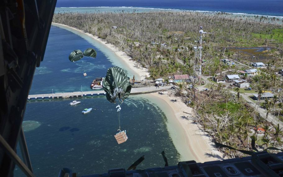 Packages make their way to the shore of Kayangel Island during an Operation Christmas Drop mission over the Pacific Ocean on Dec. 11, 2013. The island of Kayangel also experienced the devastating effects of Typhoon Haiyan that ravaged the Philippines and other islands in the area.
