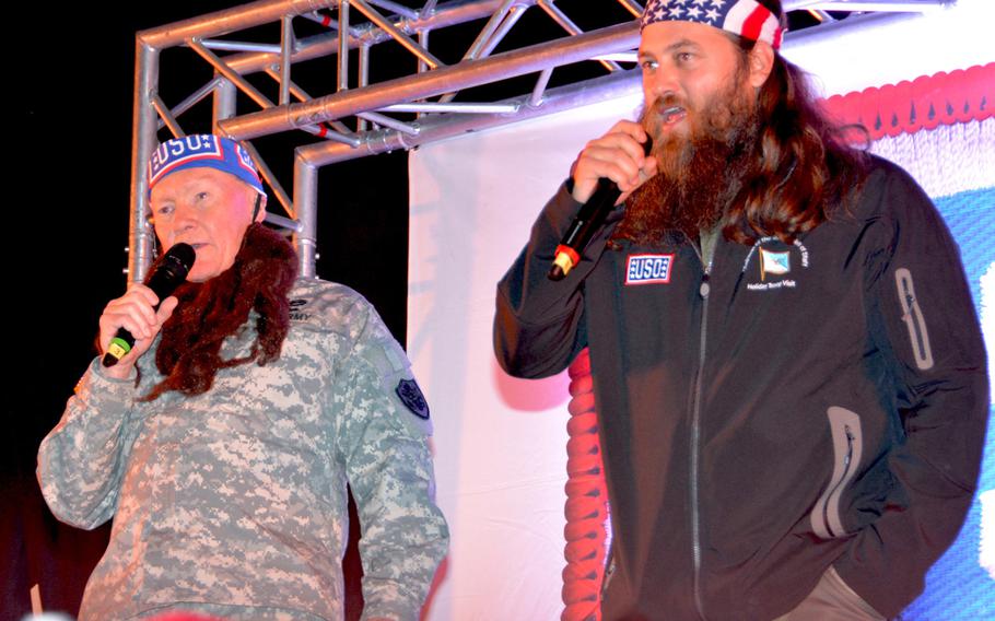 U.S. Army Gen. Martin E. Dempsey, chairman of the Joint Chiefs of Staff, dons a beard like the one sported by Willie Robertson, right, one of the stars of A&E's "Duck Dynasty," as he talks to troops on the last stop of his annual USO holiday tour in Wiesbaden, Germany, on Dec. 13, 2013.