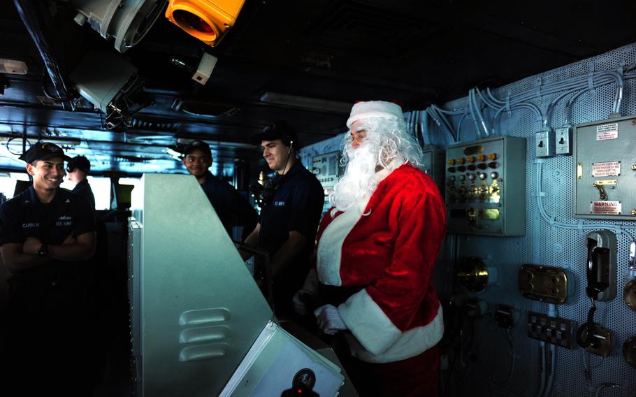 Santa Claus takes the helm on the bridge of the aircraft carrier USS Theodore Roosevelt Dec. 12, 2013. Morale, Welfare and Recreation is holding a number of holiday events onboard Theodore Roosevelt, including a Santa Claus tour around the ship. 

