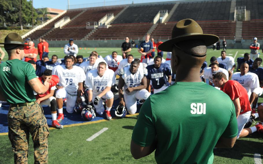 Drill instructors from Marine Corps Recruit Depot San Diego test the player's knowledge about the Marine Corps' core values of honor, courage, and commitment, and how it applied to them in their lives, the first day of practice of the Semper Fidelis All-American Bowl Jan. 1, 2014, in Santa Ana, Calif.