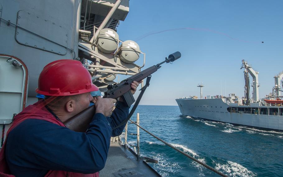 Petty Officer 2nd Class Nickolas Graham fires a messenger line from the guided-missile cruiser USS San Jacinto during a replenishment-at-sea with the Military Sealift Command oiler USNS Pecos on Dec. 28, 2013 in the Persian Gulf. The San Jacinto is deployed as part of the Harry S. Truman Carrier Strike Group supporting maritime security operations and theater security cooperation efforts in the U.S. 5th Fleet area of responsibility.