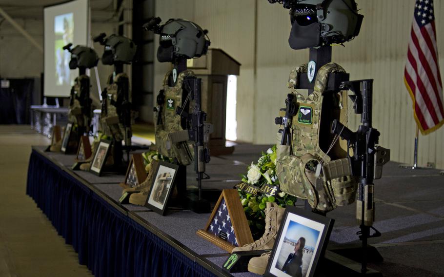 Memorials to the four airmen killed during a training exercise near Salthouse, England, line the stage before a ceremony on Friday, Jan. 17, 2014, at RAF Lakenheath, England. The airmen were with the 56th Rescue Squadron and flying in a HH-60G Pave Hawk helicopter when the crash occurred.