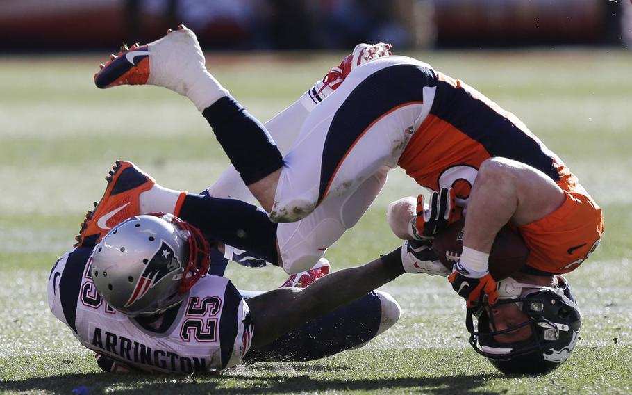 Denver Broncos wide receiver Wes Welker (83) is upended by New England Patriots cornerback Kyle Arrington (25) during the first half of the AFC Championship NFL playoff football game in Denver, Sunday, Jan. 19, 2014. (AP Photo/Julie Jacobson)