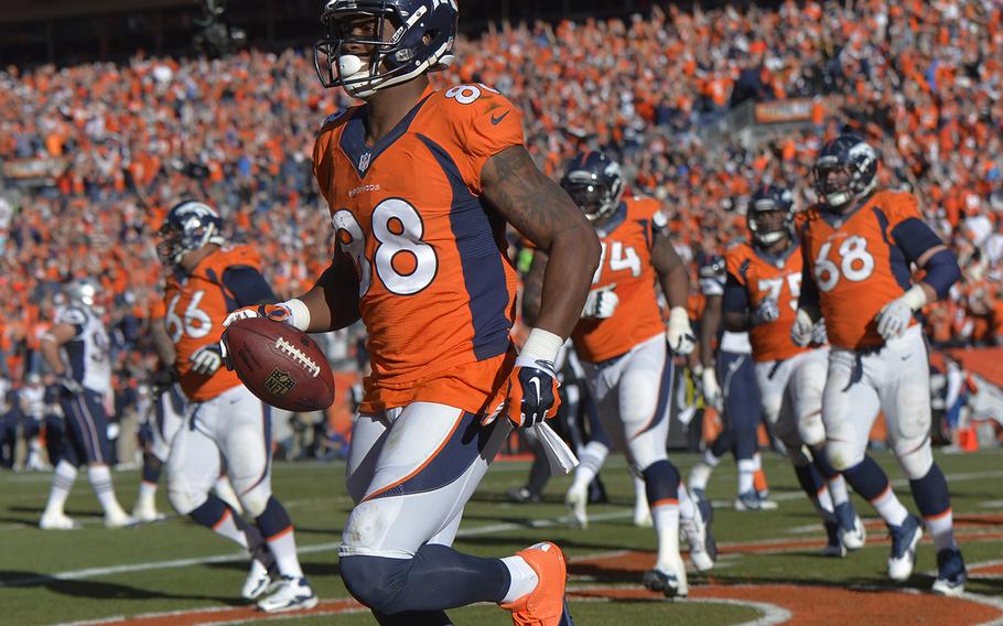 Denver Broncos wide receiver Demaryius Thomas (88) runs off the field with the ball after scoring on a three-yard touchdown pass during the second half of the AFC Championship NFL playoff football game against the New England Patriots in Denver, Sunday, Jan. 19, 2014. (AP Photo/Jack Dempsey)