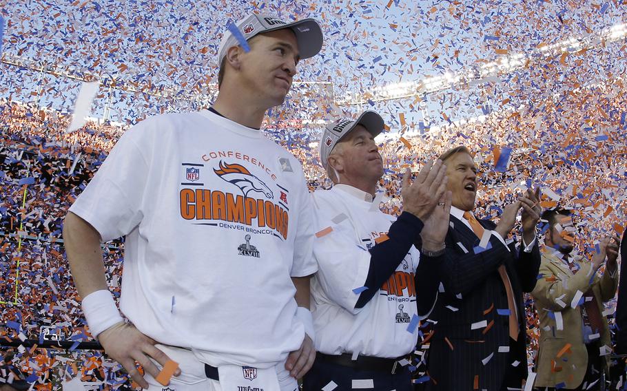 Denver Broncos quarterback Peyton Manning, stands with Broncos' head coach  John Fox and Broncos VP John Elway during the trophy ceremony after the AFC Championship NFL playoff football game in Denver, Sunday, Jan. 19, 2014. The Broncos defeated the Patriots 26-16 to advance to the Super Bowl. (AP Photo/Charlie Riedel)