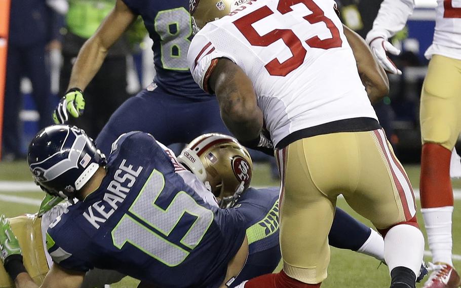 San Francisco 49ers' NaVorro Bowman injures his leg during the second half of the NFL football NFC Championship game against the Seattle Seahawks, Sunday, Jan. 19, 2014, in Seattle. (AP Photo/Elaine Thompson)