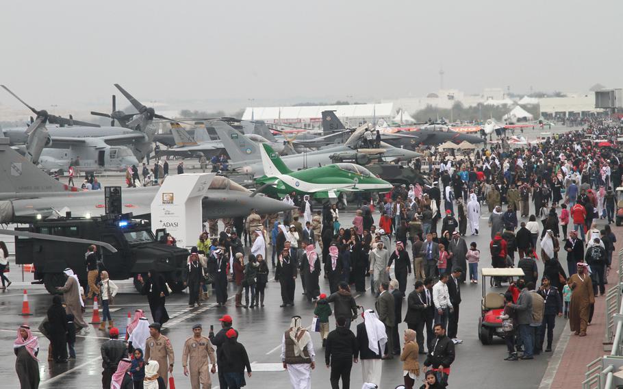 Crowds walk up and down the flightline side of the terminal at Sakhir Airbase to view various military and civilian aircraft on display at the  Bahrain International Airshow  Jan. 18, 2014.