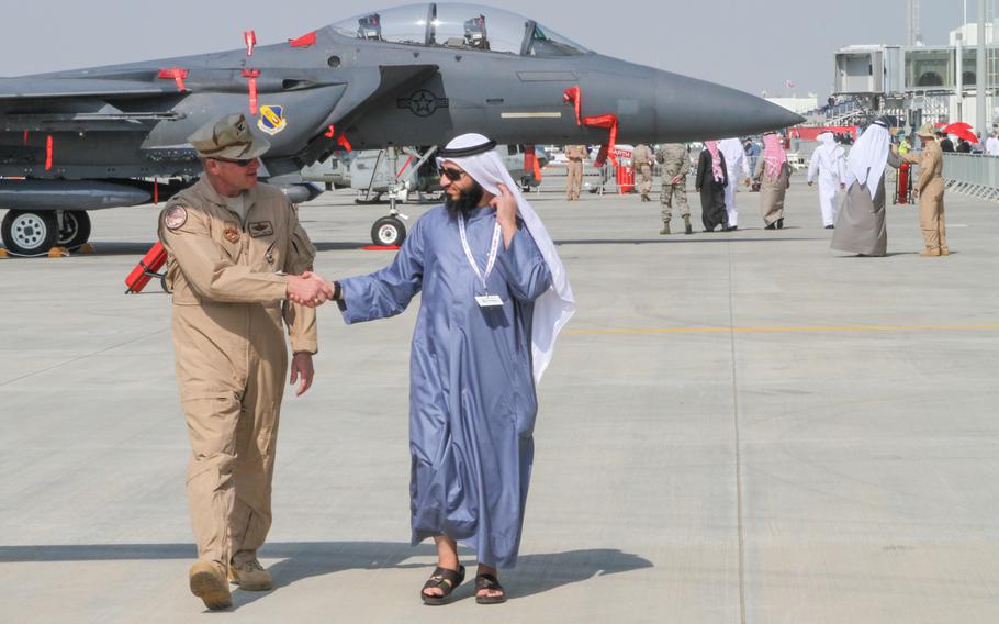 U.S. servicemembers escort visitors at the Bahrain International Airshow around U.S. military aircraft on display Jan. 16, 2014.