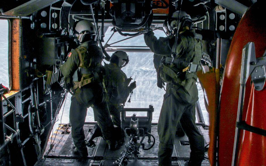 Air crewman in the back of an MH-53 Sea Dragon helicopter, from the Blackhawks of Helicopter Mine Countermeasures Squadron 15, prepare for a methodical mine sweeping process in which the helicopter tows underwater equipment that can cut the chains off sea mines, thereby revealing them when they float to the surface. The crew was participating in an International Mine Countermeasures Exercise on May 17, 2013 in the Persian Gulf.