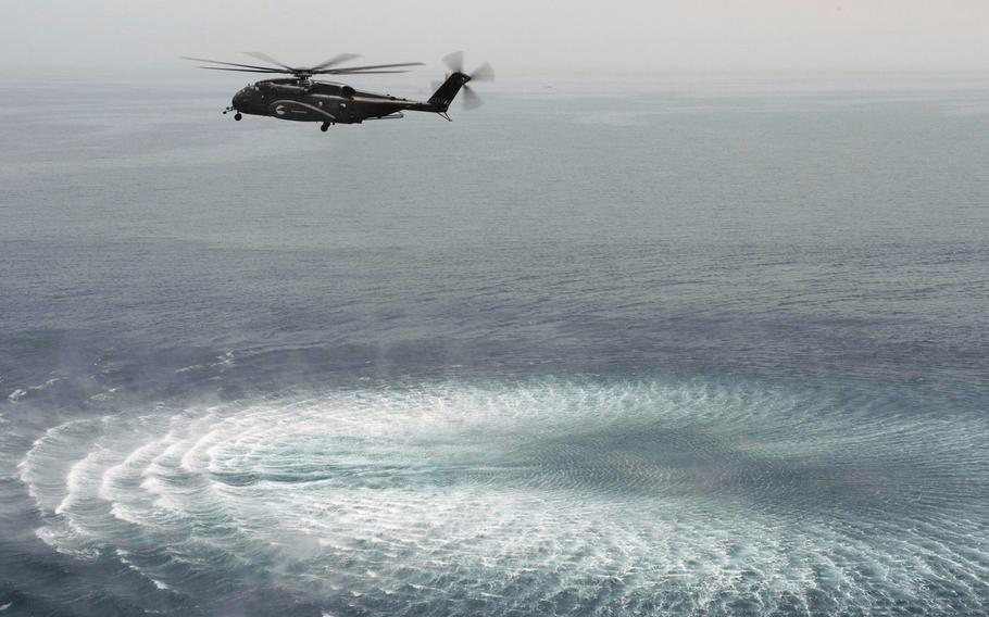 An MH-53E Sea Dragon helicopter assigned to Helicopter Mine Countermeasures Squadron 15, maneuvers in position during a training mission in the U.S. 5th Fleet area of responsibility on May 21, 2013.