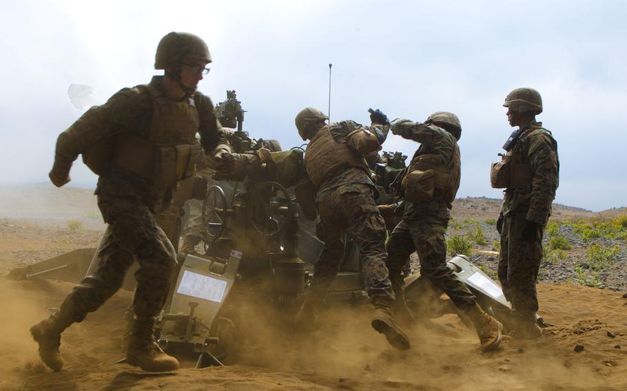 U.S. Marines with 1st Battalion, 12th Marines, load a M777A2 Howitzer during a live-fire operation aboard Camp Pohakuloa, Hawaii, on Jan. 19, 2014.