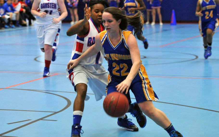 Wiesbaden's Rebecca Russell drives to the basket against Ramstein's D'Myia Thornton in a game at Ramstein, Germany, Saturday, Jan. 25, 2014. The Warriors defeated the Royals 35-33.