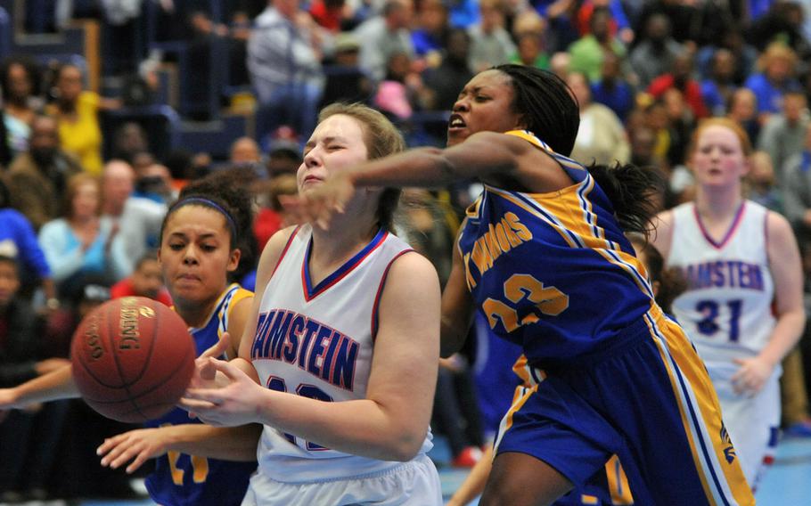Wiesbaden's Marquala Scott, left, could only stop Ramstein's Sofia Dinges with a foul in this play during a game at Ramstein, Germany, Saturday, Jan. 25, 2014. The Warriors defeated the Royals 35-33. At left is Wiesbaden's Dominique Baldwin.