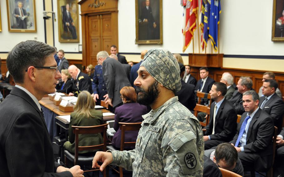Army Reserve Maj. Kamal S. Kalsi speaks with U.S. Rep. Joe Heck, R-Nev., before the start of a hearing on a new Defense Department directive that provides guidance on uniforms and grooming with respect to religious beliefs at a House Armed Services Committee personnel subcommittee on Capitol Hill on Wednesday, Jan. 29, 2014.