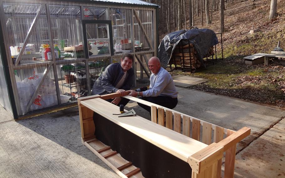 Injured Navy veteran Michael Baker, left, and his life coach Joe Olivito built wheelchair-accessible gardening beds at his home in West Virginia last fall. Baker and his family receive financial assistance through the Wounded Warrior Project's Independence Program.