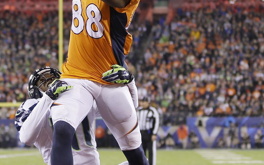 Denver Broncos' Demaryius Thomas catches a pass for a touchdown while covered by Seattle Seahawks' Byron Maxwell during the second half of the NFL Super Bowl XLVIII football game Sunday, Feb. 2, 2014, in East Rutherford, N.J. (AP Photo/Mark Humphrey)